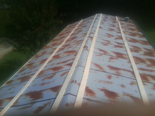 Rusted metal roof panels with new wood purlins before replacement — Storm Damage Roof Repair in Manasquan by Roofing Brothers